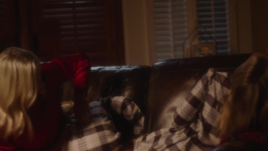 A family in pajamas plays and bonds on the couch