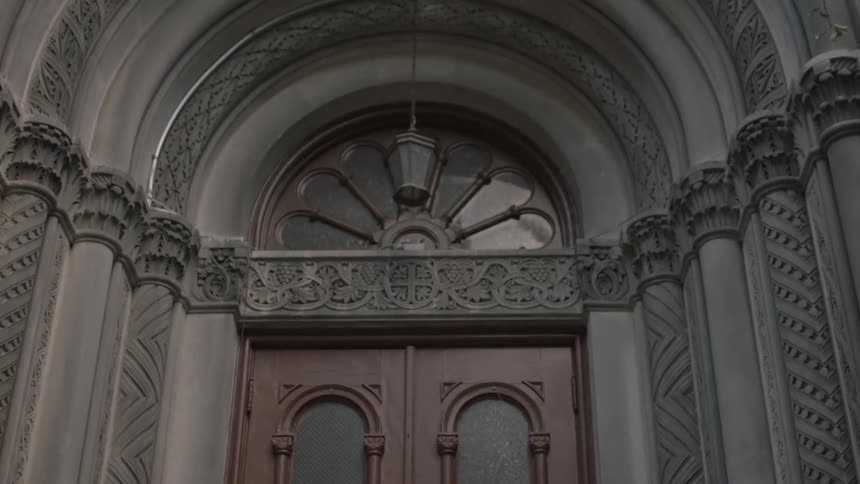 An ornate building with dark red doors