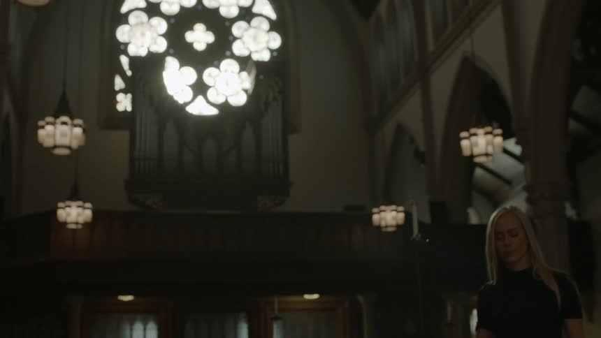 Woman walking in and standing in a church