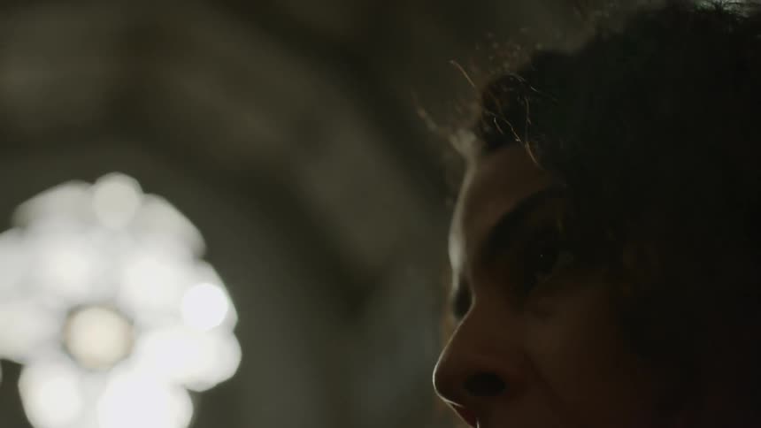 Woman in a church turning her head and looking around
