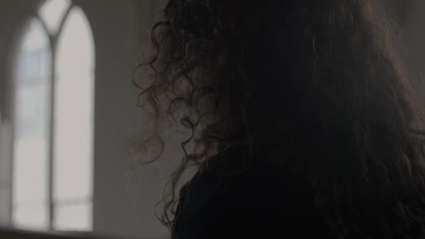 Close up of the back of a woman in church