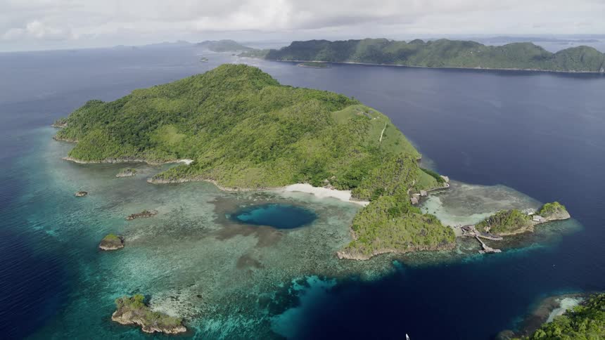 Aerial view of islands in the ocean with overcast skies during the day