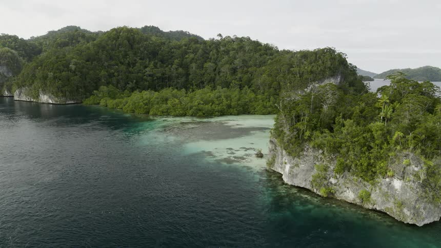Large and small lush green islands out at sea with coastlines
