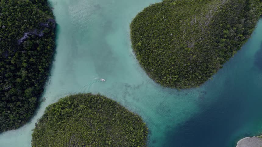 Aerial view of three islands and water in sunlight