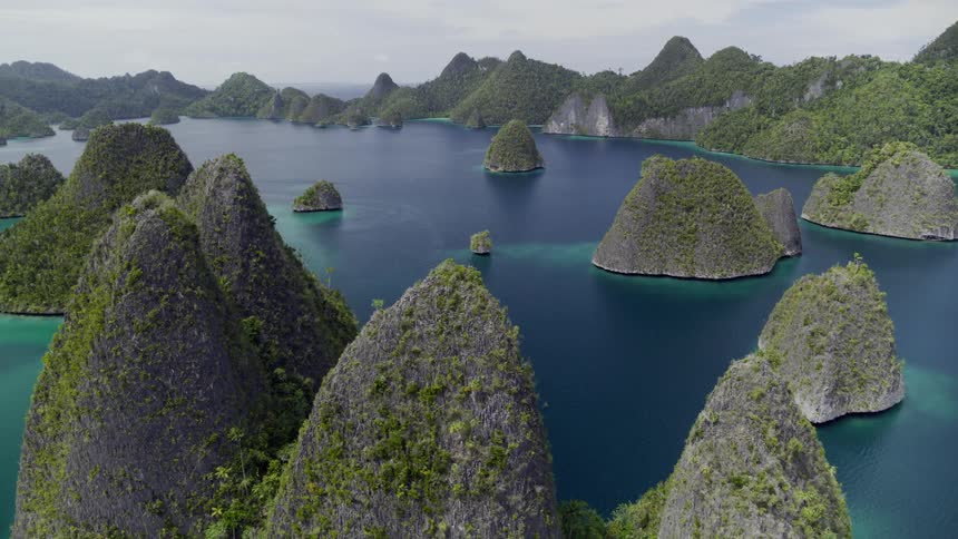 Stone islets covered in vegetation peek up through the ocean during the day