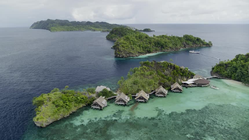 Houses in an island resort near the coast with the ocean the sky and clouds in the background
