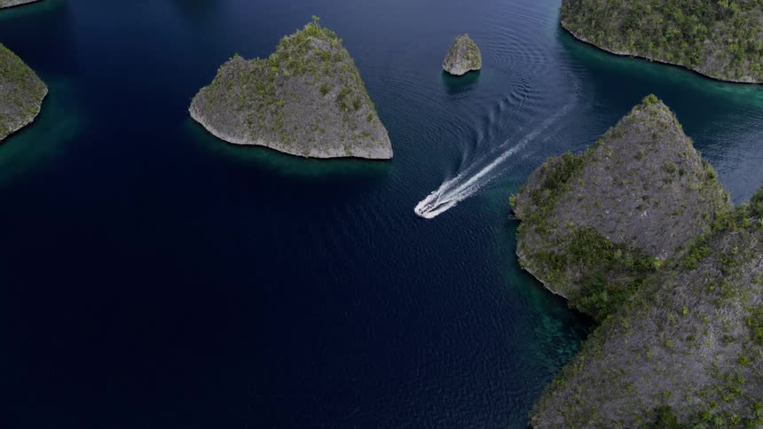 A speedboat travels between a set of islands