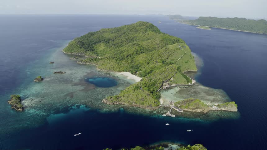 Aerial view of an tropical island with clear ocean water