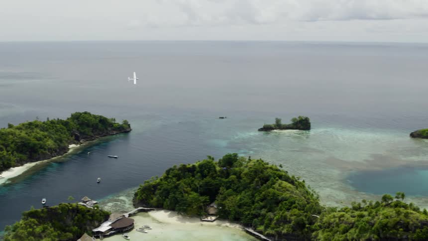 A small plane flies over the islands of an archipelago on a cloudy day