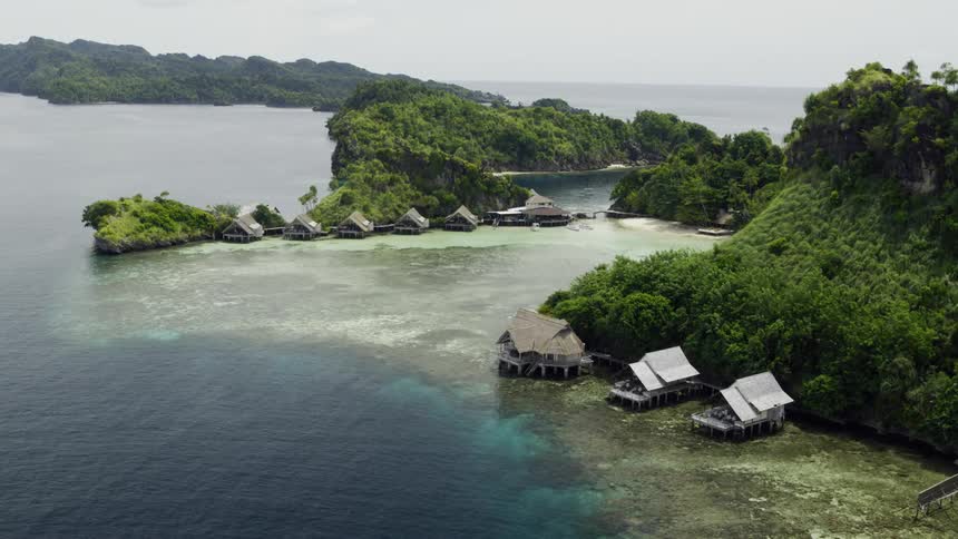 Huts in a lagoon off the shore of an island in an archipelago