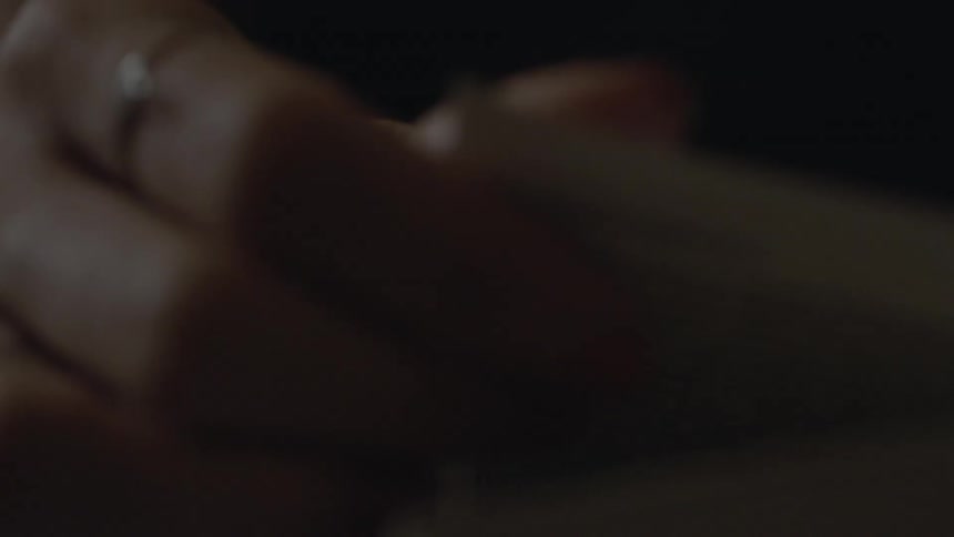 Female hands turn the pages of a book