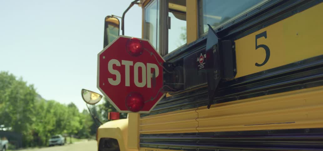 School bus with and a stop sign with a flashing red light