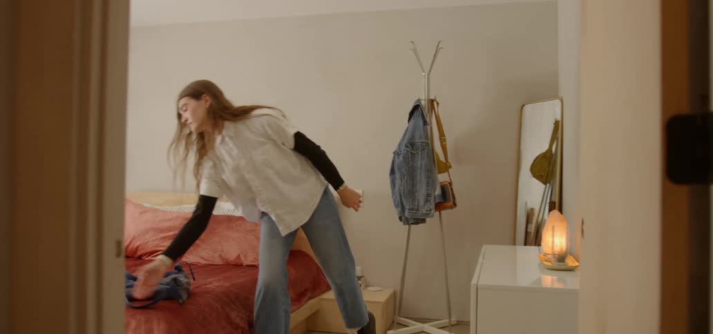 Woman getting ready and walking out of a doorway