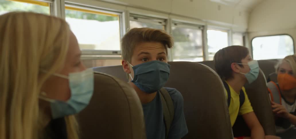 Children talk while riding in the school bus