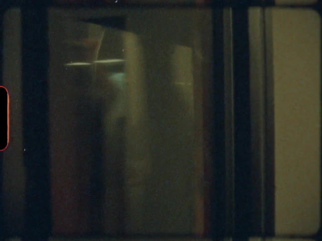 Passengers can be seen in glass of subway train