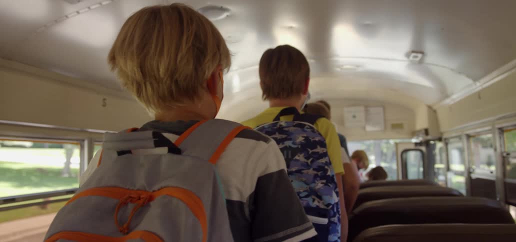 Children walk off the school bus