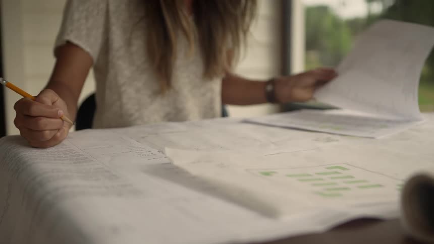 Woman writing on a large piece of paper