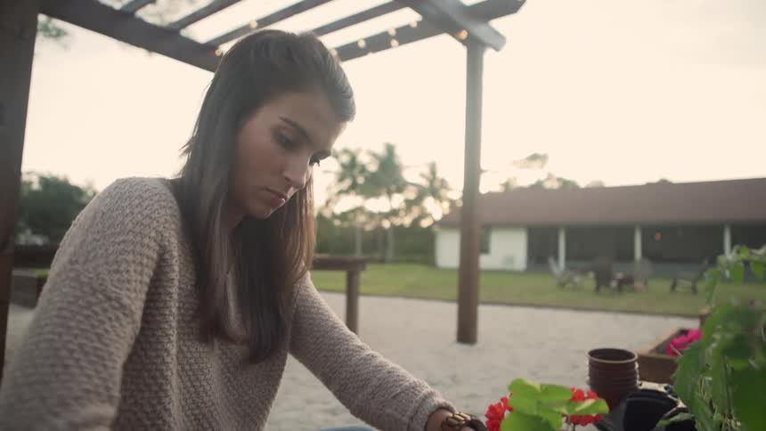 A woman is gardening in her yard