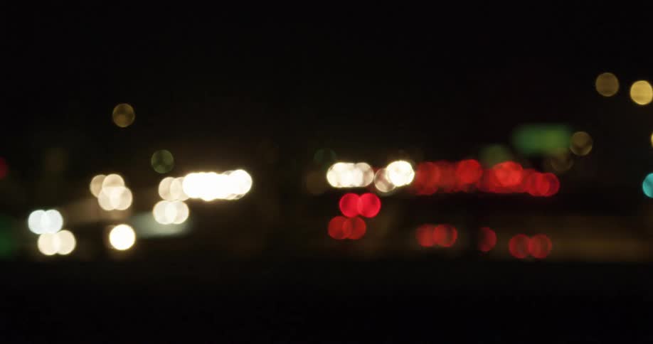 Vehicles drive on a busy highway at night