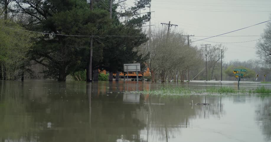 The high murky waters of a flooded intersection on a cloudy day