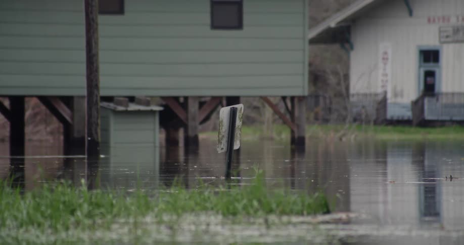 Stream of water flowing by under a dock house
