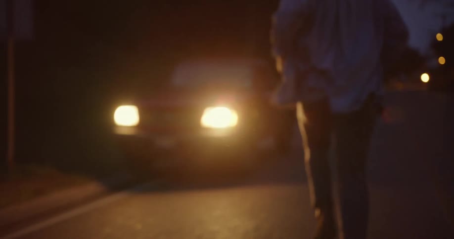 A man runs down the road to get in his vehicle