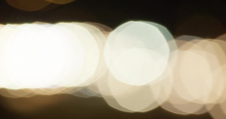 Large spots of light glare flow past as lights blink