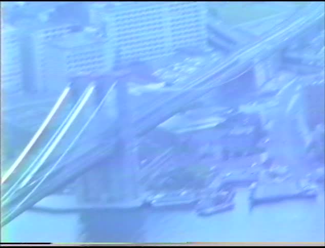 Bridges over water with buildings roads and vehicles in a city