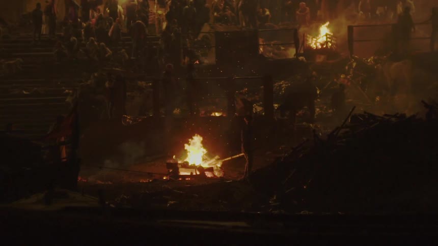People gather in a public area and watch bonfires burning