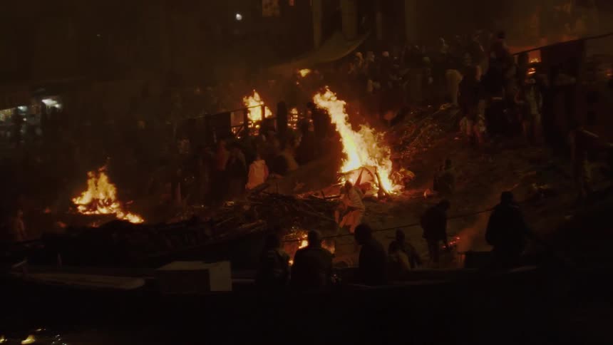 People watch as flames engulf buildings