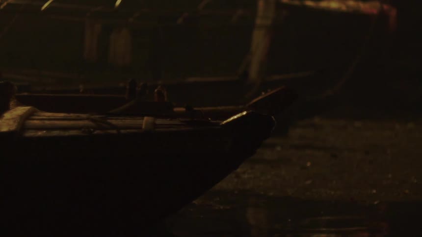 Boats out of water in a boat yard at night time