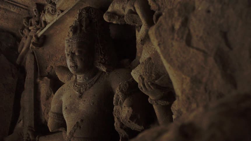 Ancient stone statue inside of a building