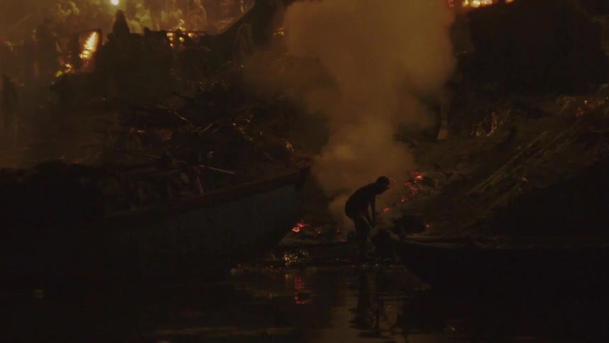 A person is digging through the rubble of a disaster