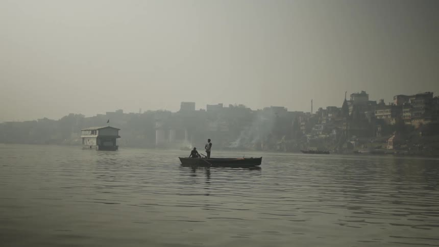 People sailing on a boat towards the shore