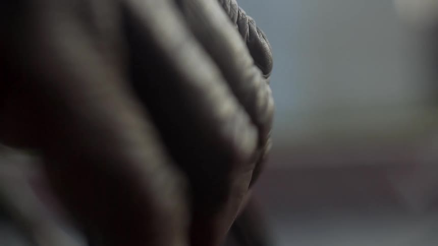 Senior hand holding onto a metal bar