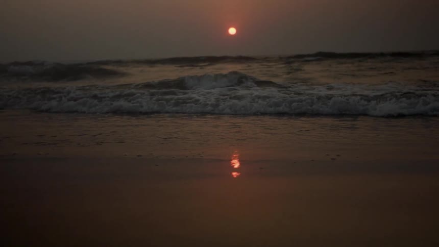 Waves rolling in to the shore as the sun sets