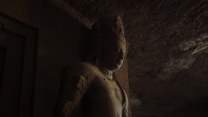 A stone statue in a dark room
