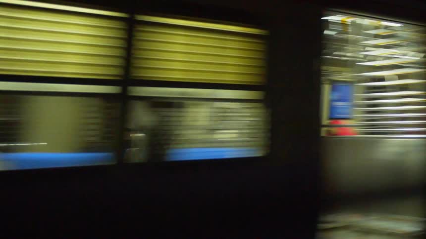 Exterior of a train moving with lights coming from the cars