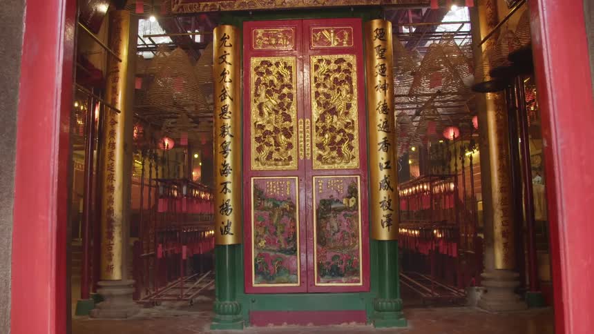 Grand doors in gold red and black with columns to an asian temple