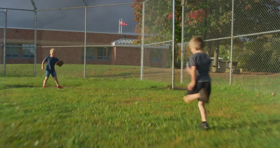 A young boy runs the bases at a baseball game