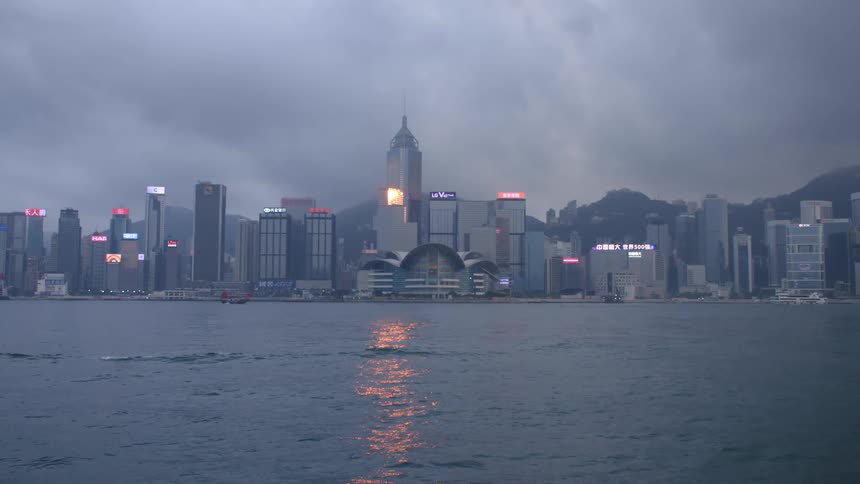 City view with large buildings and skyscrapers next to a body of water