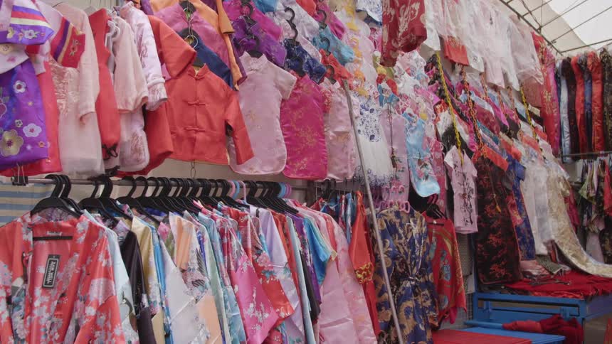 A clothing store with clothing hanged up on hangers