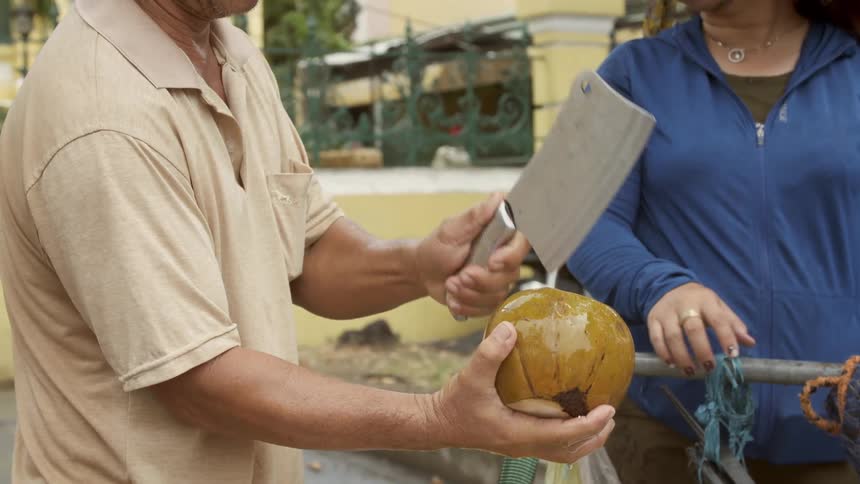 Opening a coconut at a food truck