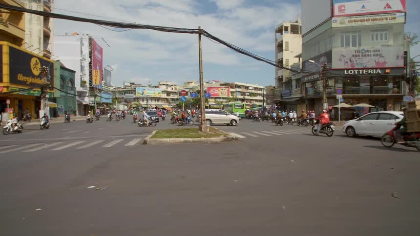 Vehicles driving on a busy street in a large city