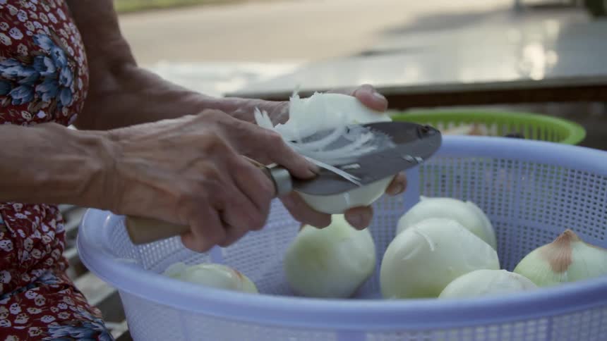 A woman slicing onions