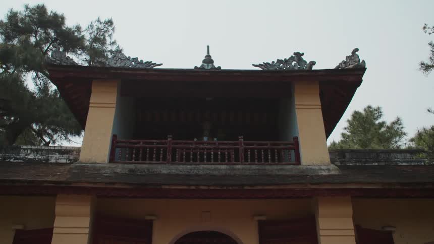 Exterior of an asian temple with trees in the background and blue sky