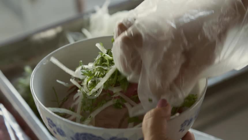Preparing a bowl of local asian food