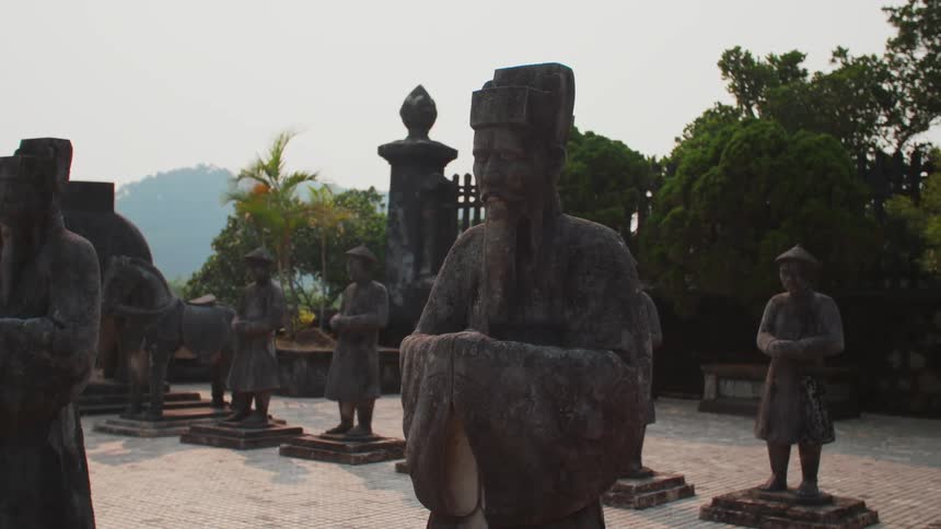 Old statues lined up outside of a courtyard