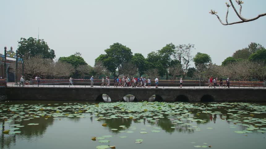 Tourist walking on a bridge at a historical site in daytime