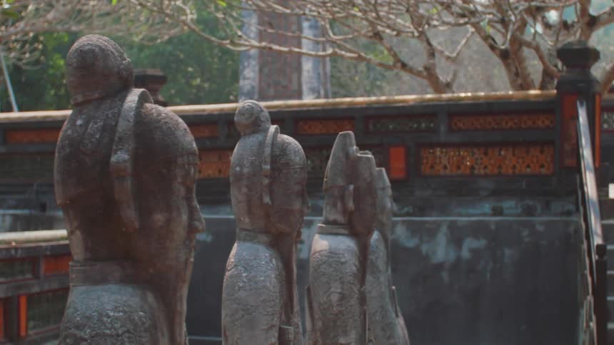 Statues in front of a building in a city